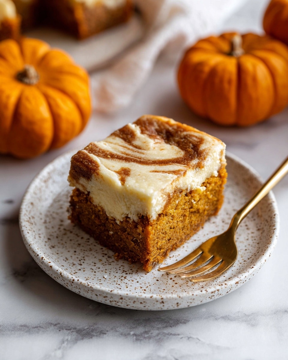 A square piece of swirled pumpkin cheesecake bar sits on a white speckled plate with a gold fork beside it, holding a small bite-sized piece of cake. The cake has two main layers: a bottom and middle layer of moist, spongy, light brown pumpkin cake, and a creamy, pale cheesecake layer swirled within the top, creating a marbled effect on the surface. The plate rests on a white marbled surface, with two small orange pumpkins blurred in the background. photo taken with an iphone --ar 4:5 --v 7