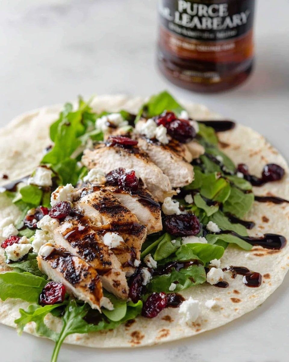 A white flat tortilla on a white marbled surface holds a layer of fresh green arugula leaves, topped with thick slices of grilled chicken breast with dark grill marks. Scattered over the chicken and greens are crumbles of soft white cheese and small pieces of dried red cranberries. The whole wrap is drizzled with a glossy, dark balsamic glaze, creating a contrast against the light colors of the other ingredients. In the background, a bottle of Pure Leaf raspberry tea is slightly out of focus, adding context to the meal. photo taken with an iphone --ar 4:5 --v 7