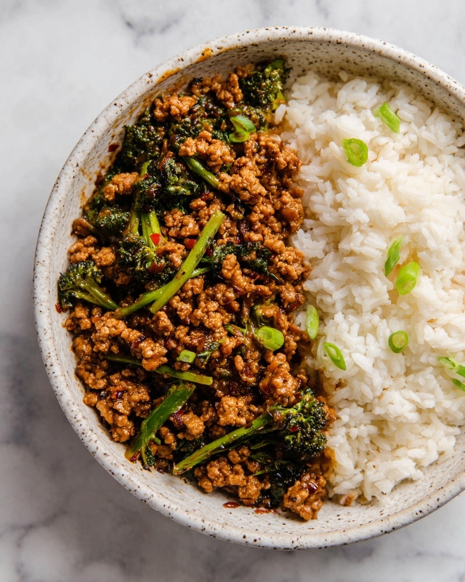 The image shows two cut wrap sandwiches stacked on a white plate. Each wrap has a visible outer layer of a soft, lightly toasted tortilla with a brown swirl pattern. Inside, there is a leafy green lettuce layer close to the tortilla, followed by plump grilled shrimp with light char marks on top. Bright orange pieces of grilled bell pepper peek through among the shrimp. A creamy, pale green sauce or spread is lightly spread around the shrimp and vegetables, adding texture and contrast. The plate sits on a smooth white marbled surface. Photo taken with an iphone --ar 4:5 --v 7