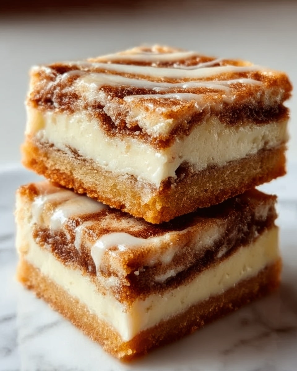 The image shows two square pieces of a layered dessert stacked on a white marbled surface. Each piece has three layers: a golden-brown crust layer at the bottom, a thick, creamy white layer in the middle, and a swirled layer of brown cinnamon filling mixed with the creamy layer, creating a marbled effect. The top layer is drizzled with a light glaze that glistens under the light, adding a shiny texture. The edges are slightly crumbly with a soft and moist interior, making the dessert look rich and inviting. Photo taken with an iphone --ar 4:5 --v 7